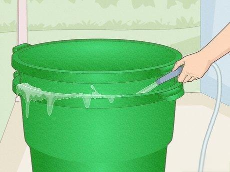 Filling water in green stacked plastic buckets
